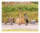 PREORDER Busch HO 79941 Stacking Wood, Action Set, Includes Worker, Wheelbarrow, Hand Tools, Wood Pile Come, 4 Stumps,