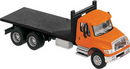 Walthers SceneMaster 949-11651 International(R) 7600 3-Axle Flatbed Truck - Assembled - Orange Cab, Black Flatbed, HO
